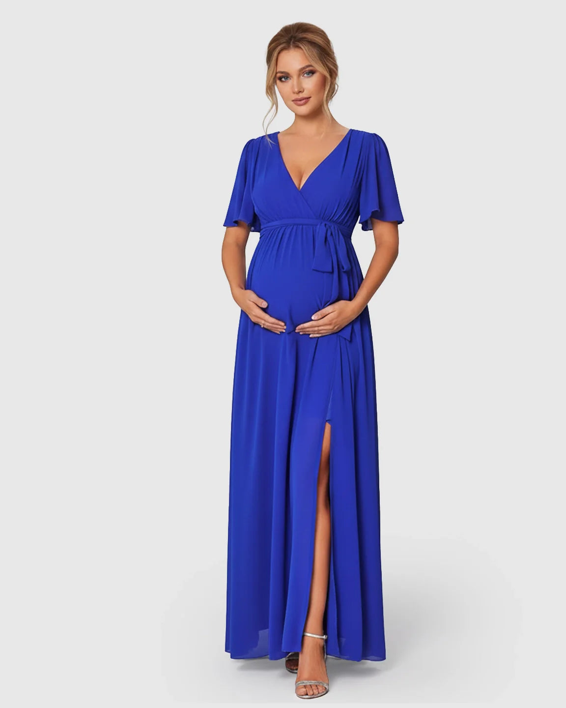 Maternity maxi dress in royal blue with surplice V-neck, flutter sleeves, empire waist tie, and front slit.