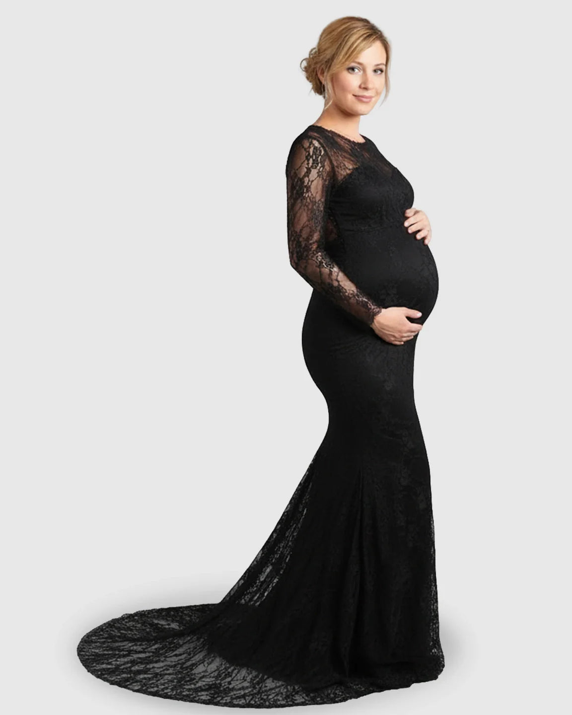 Pregnant woman in a black sheer lace trumpet maternity photoshoot gown with long sleeves and a mermaid skirt.