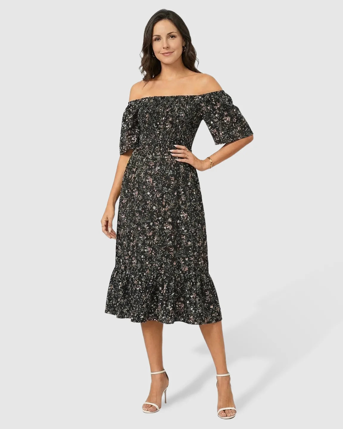 Black floral off-shoulder smocked maternity midi dress with flutter sleeves and tiered skirt.
