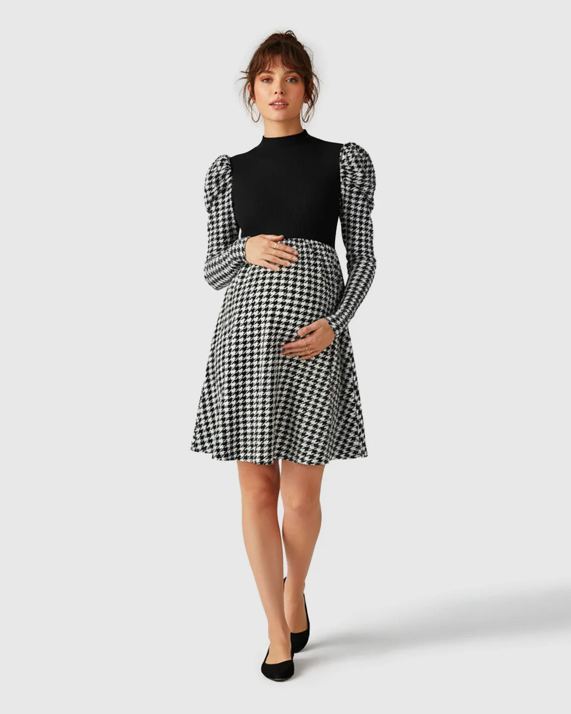 Maternity short dress with black knit bodice, houndstooth skirt, and puff sleeves.