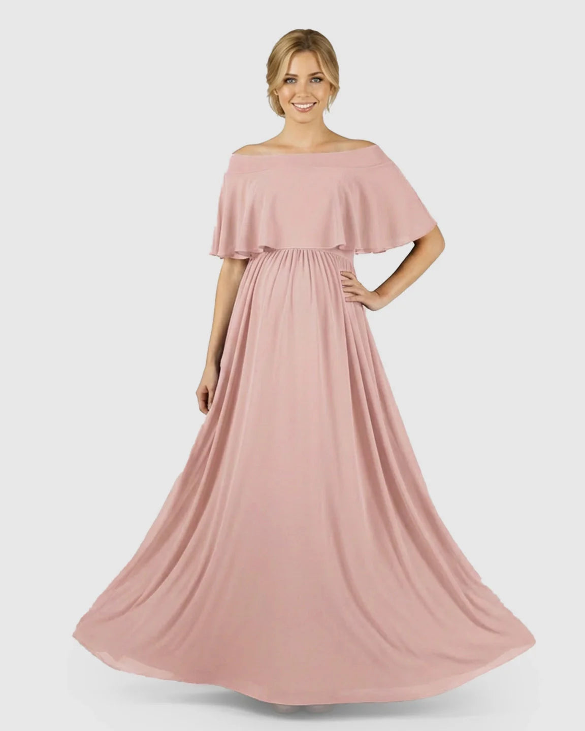 Blonde pregnant woman in a flowy, blush pink chiffon off-shoulder bohemian maternity photoshoot dress.