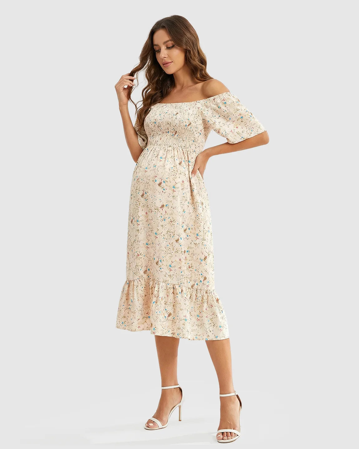 Maternity midi dress with flutter sleeves, smocked bodice, and floral print on light fabric.