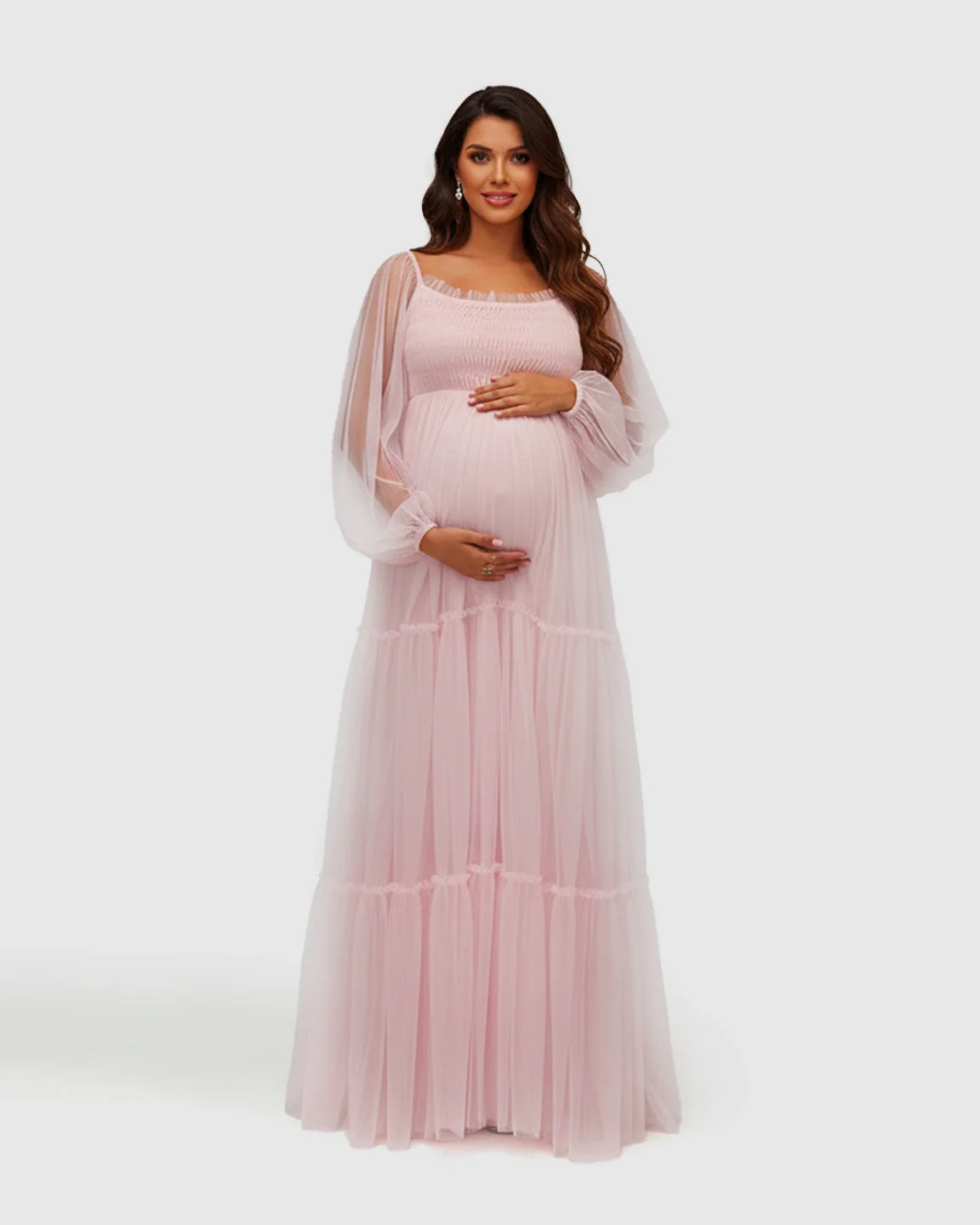 Pink tiered tulle maternity gown with lantern sleeves, smocked bodice, and lace trim.