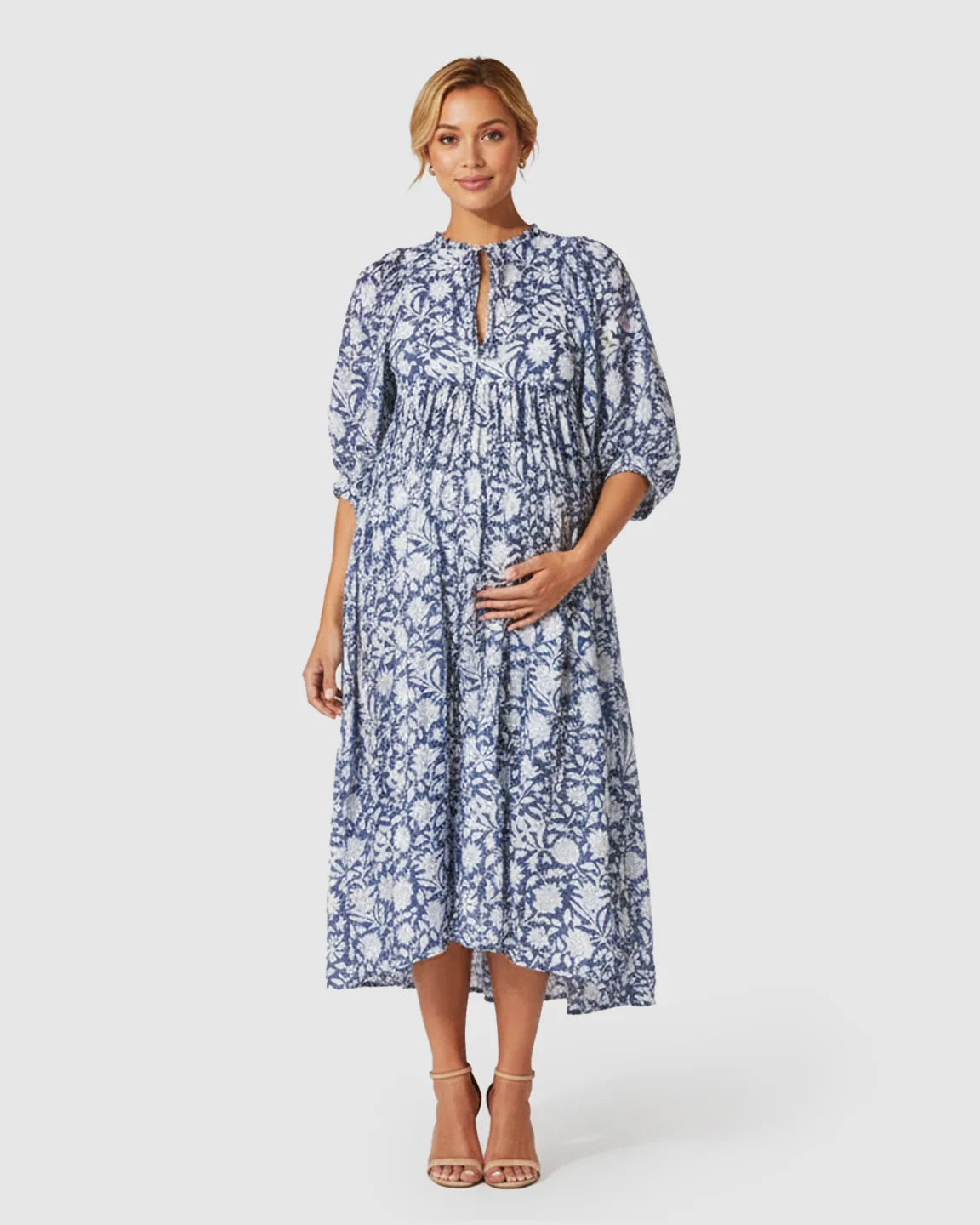 Maternity midi dress in blue and white floral print with gathered shoulders, puff sleeves, and a relaxed fit.