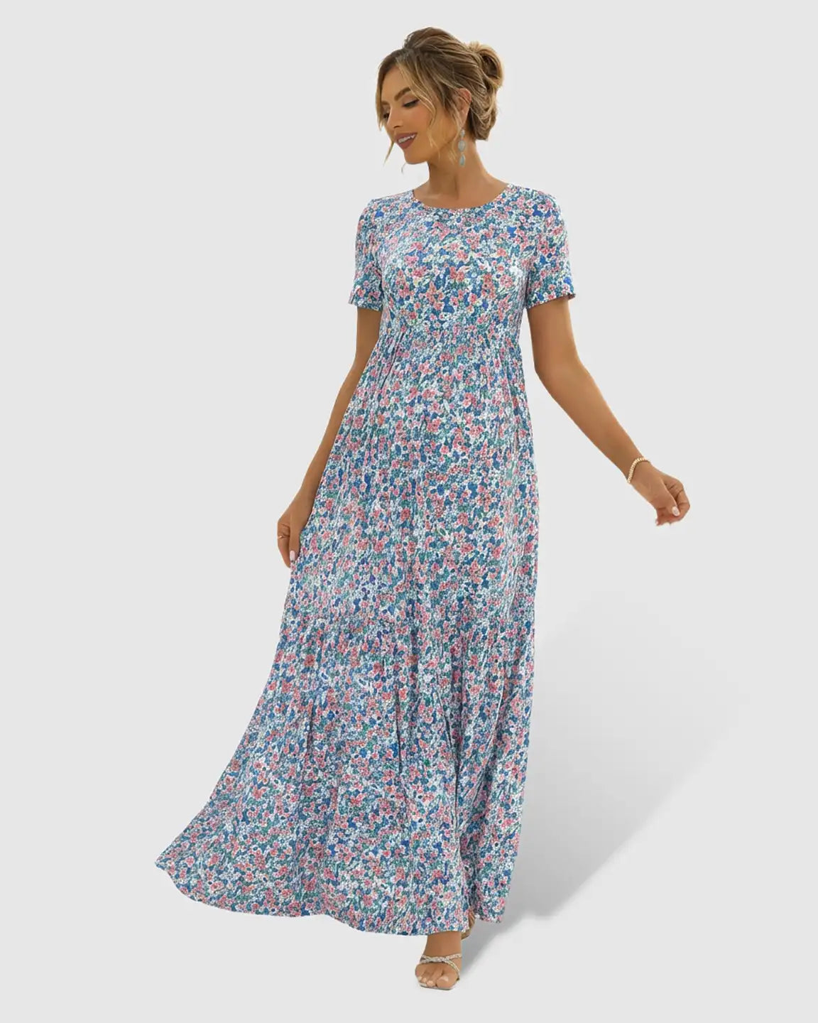 Flowy floral-pastoral maternity maxi dress with short sleeves, round neckline, and tiered chiffon skirt.
