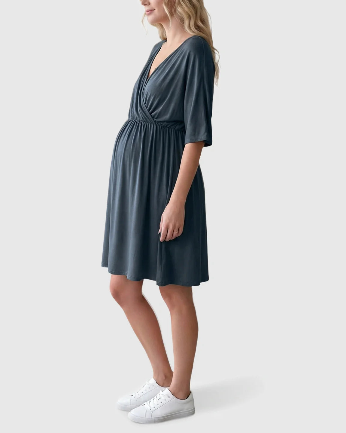 Pregnant woman in a charcoal gray cross-front maternity midi dress with 3/4 sleeves and a flowy A-line silhouette.