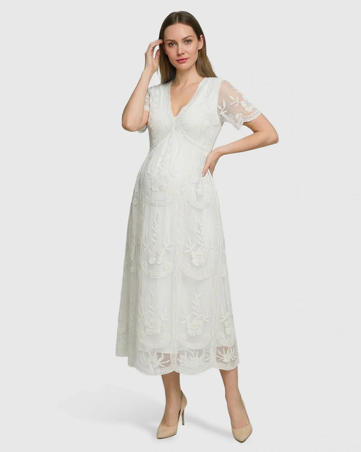 White lace maternity midi dress with V-neck, three-quarter sleeves, and embroidered swing skirt.