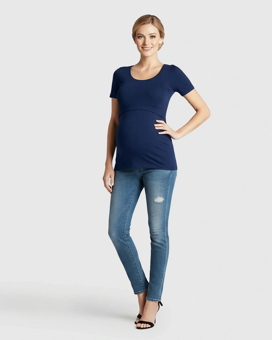 Smiling model in a navy stretch-fit V-neck nursing t-shirt and jeans.