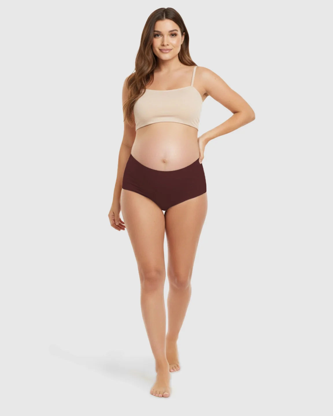 Pregnant woman models seamless high-waist support maternity underwear in a deep maroon color.