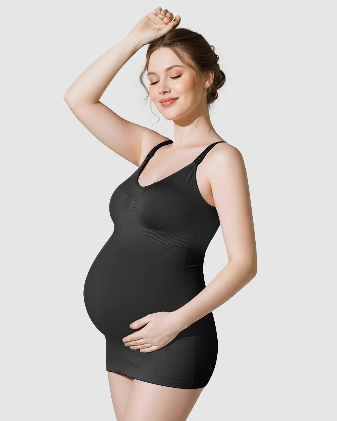 Pregnant woman wearing a black soft stretch front-opening wireless maternity nursing bra and matching slip.