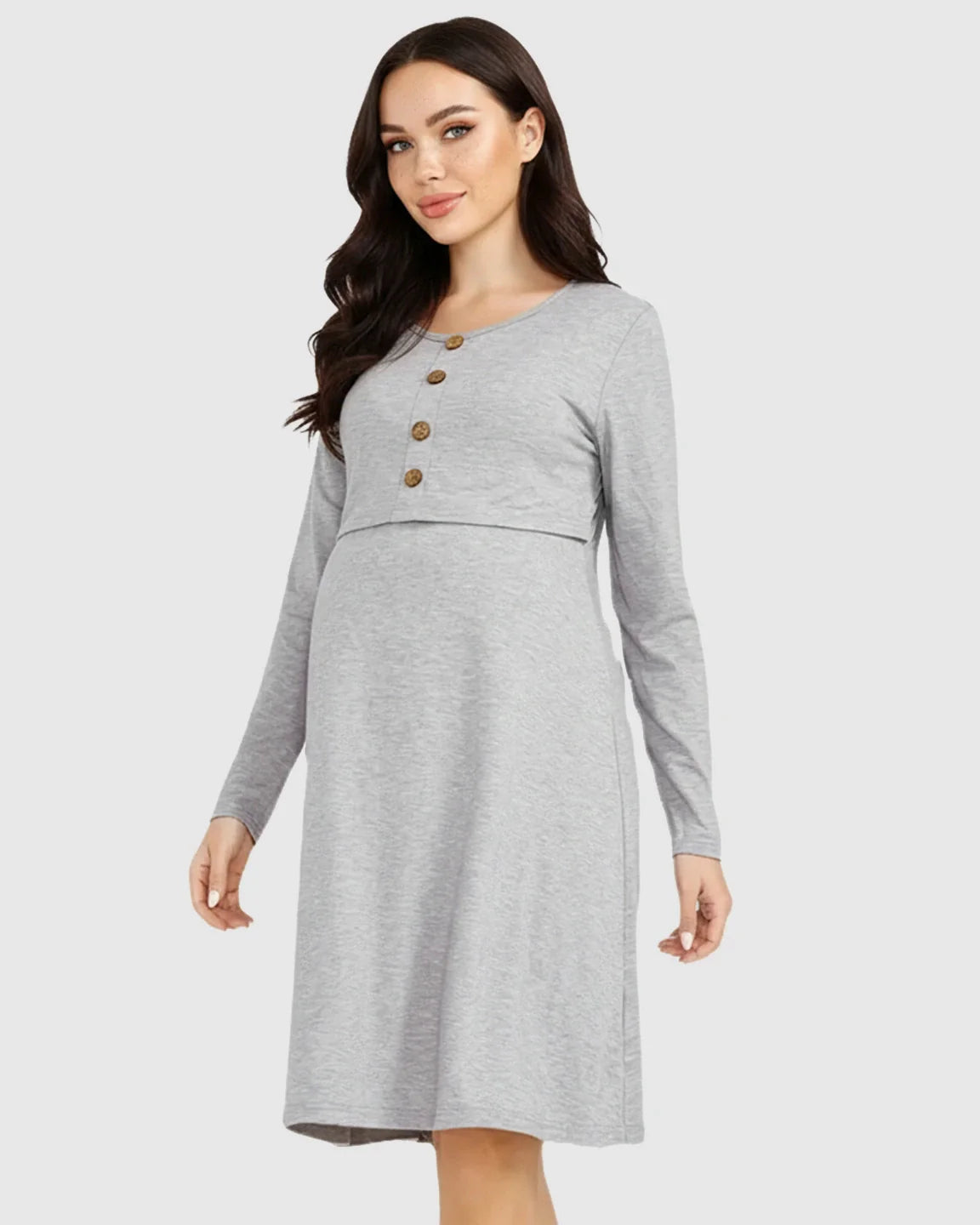 Woman wearing a gray long-sleeve empire waist nursing dress with brown buttons.