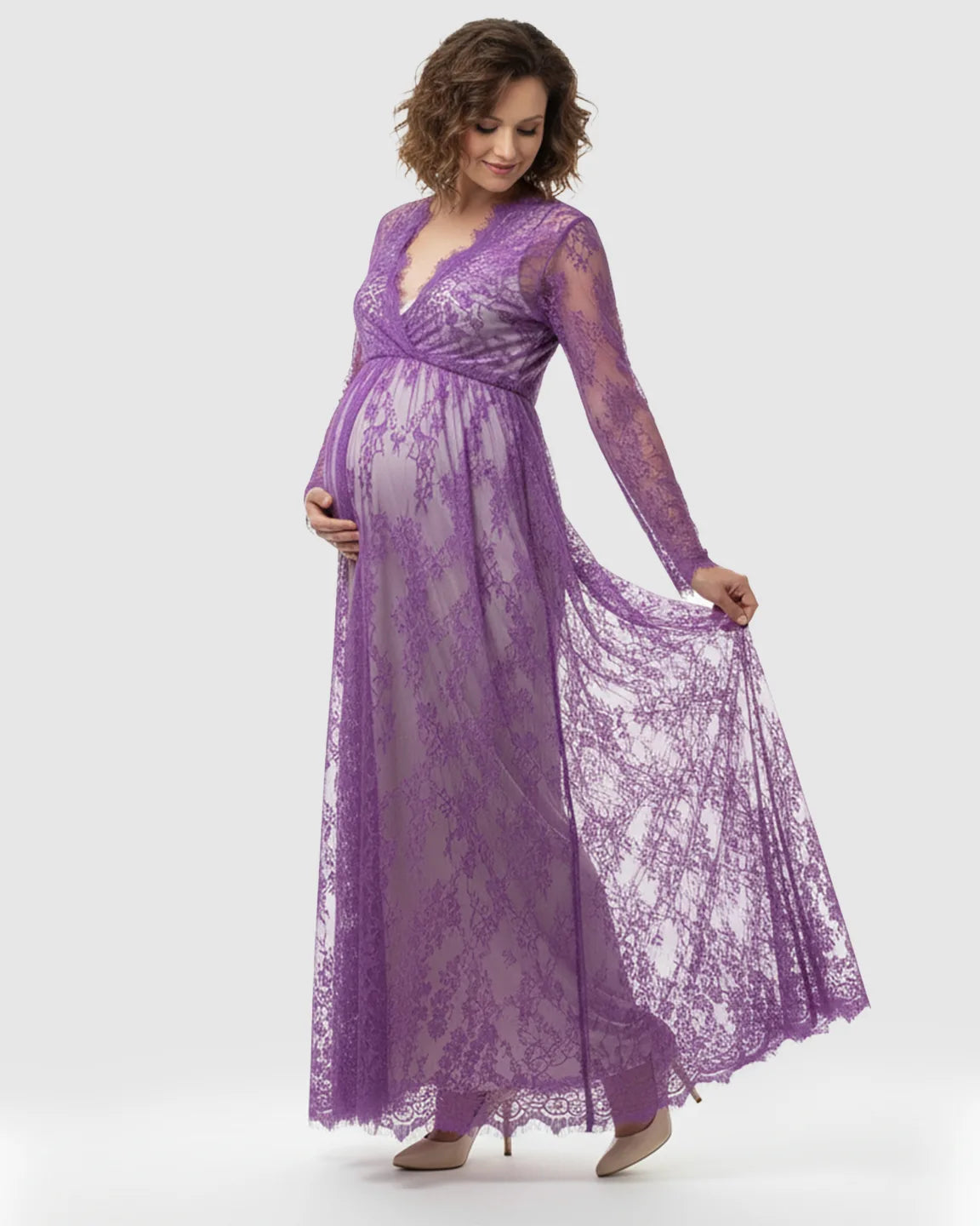 Maternity maxi dress in sheer floral purple lace with an empire waist and long sleeves.
