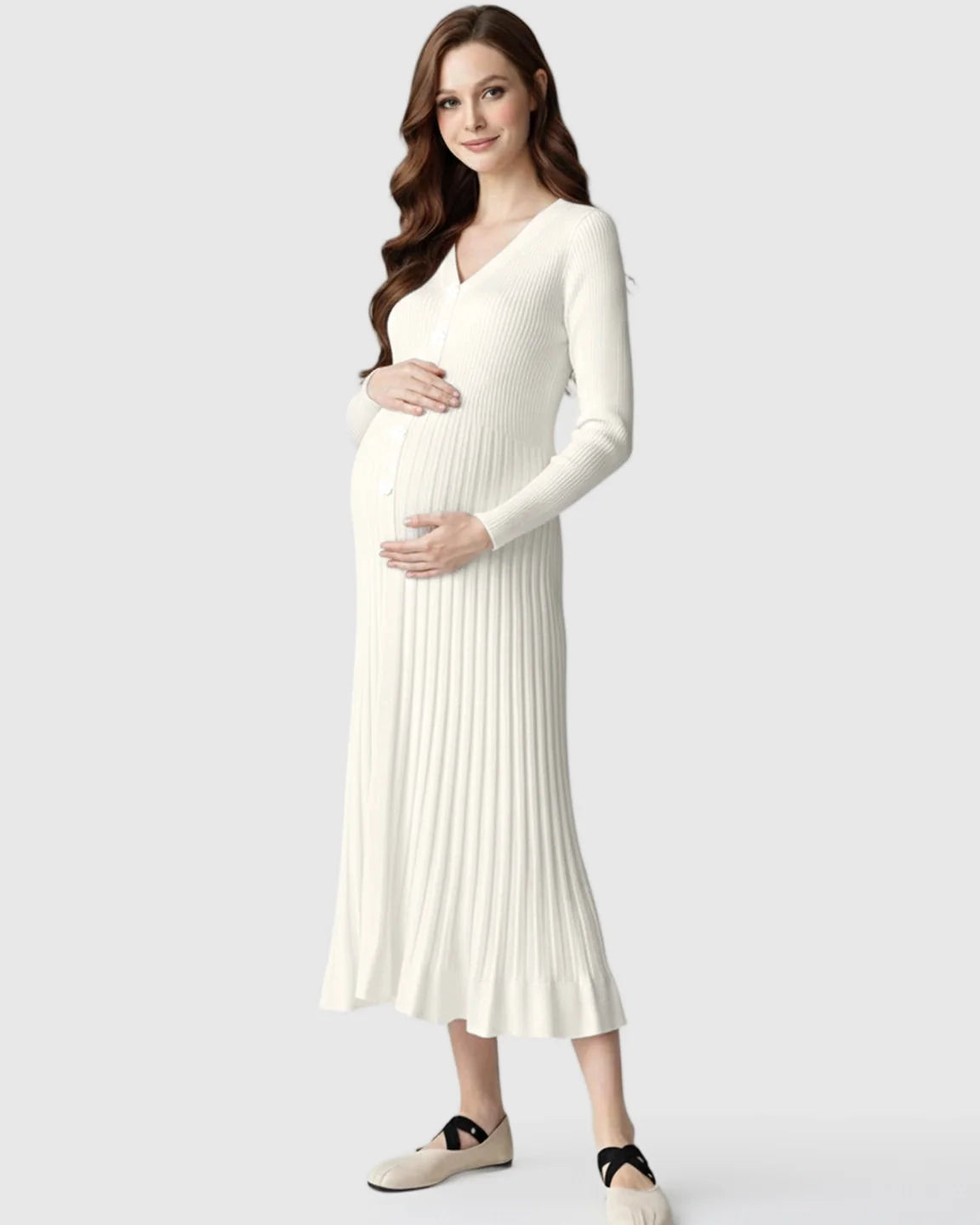 Pregnant model in a cream ribbed knit maternity midi dress with long sleeves and a V-neck.