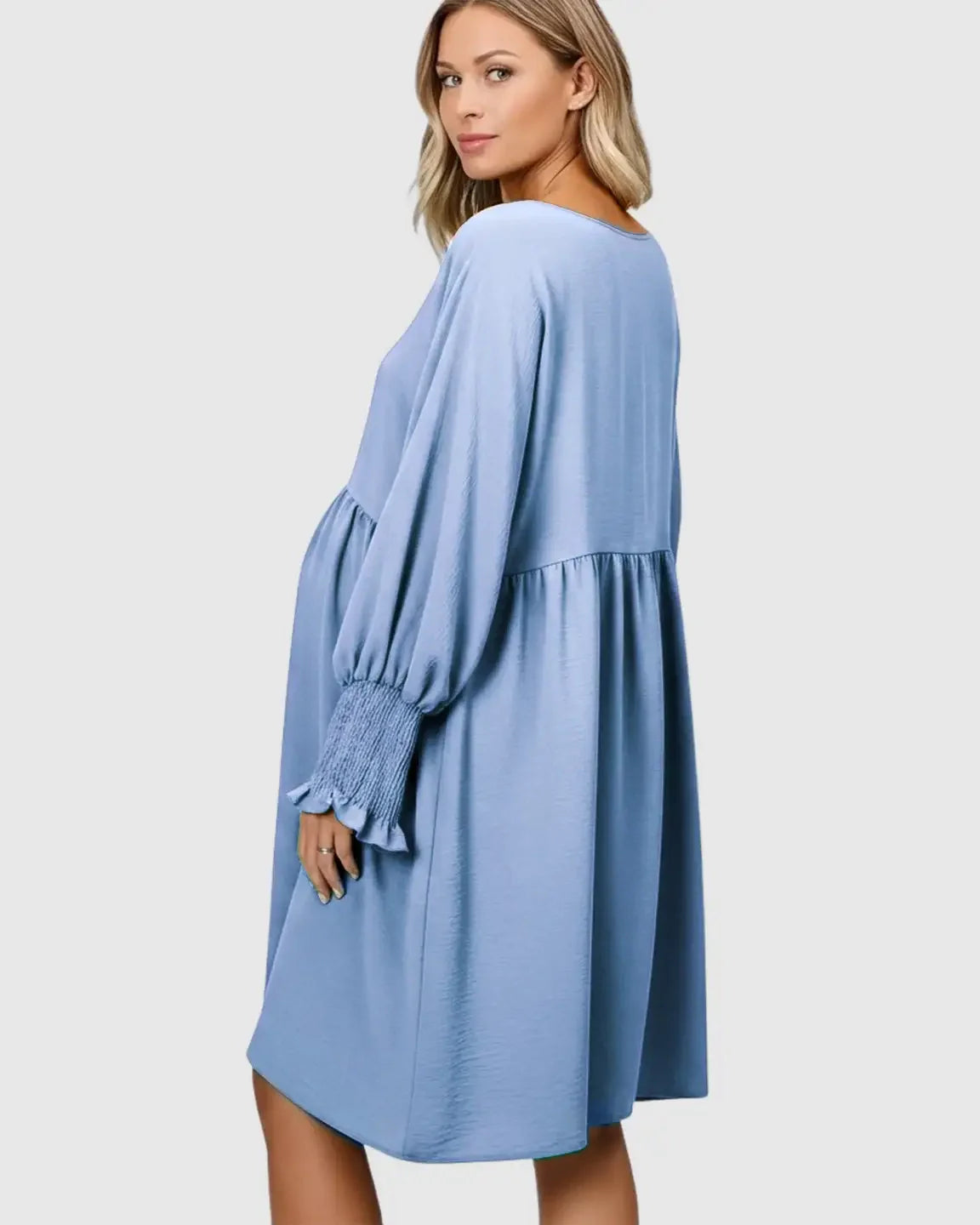 Pregnant woman in a blue flowy smocked sleeve casual dress with a round neckline.