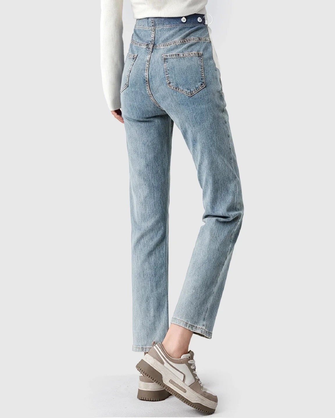 Light wash stretch denim straight-leg maternity jeans with adjustable button waistband, shown from behind.