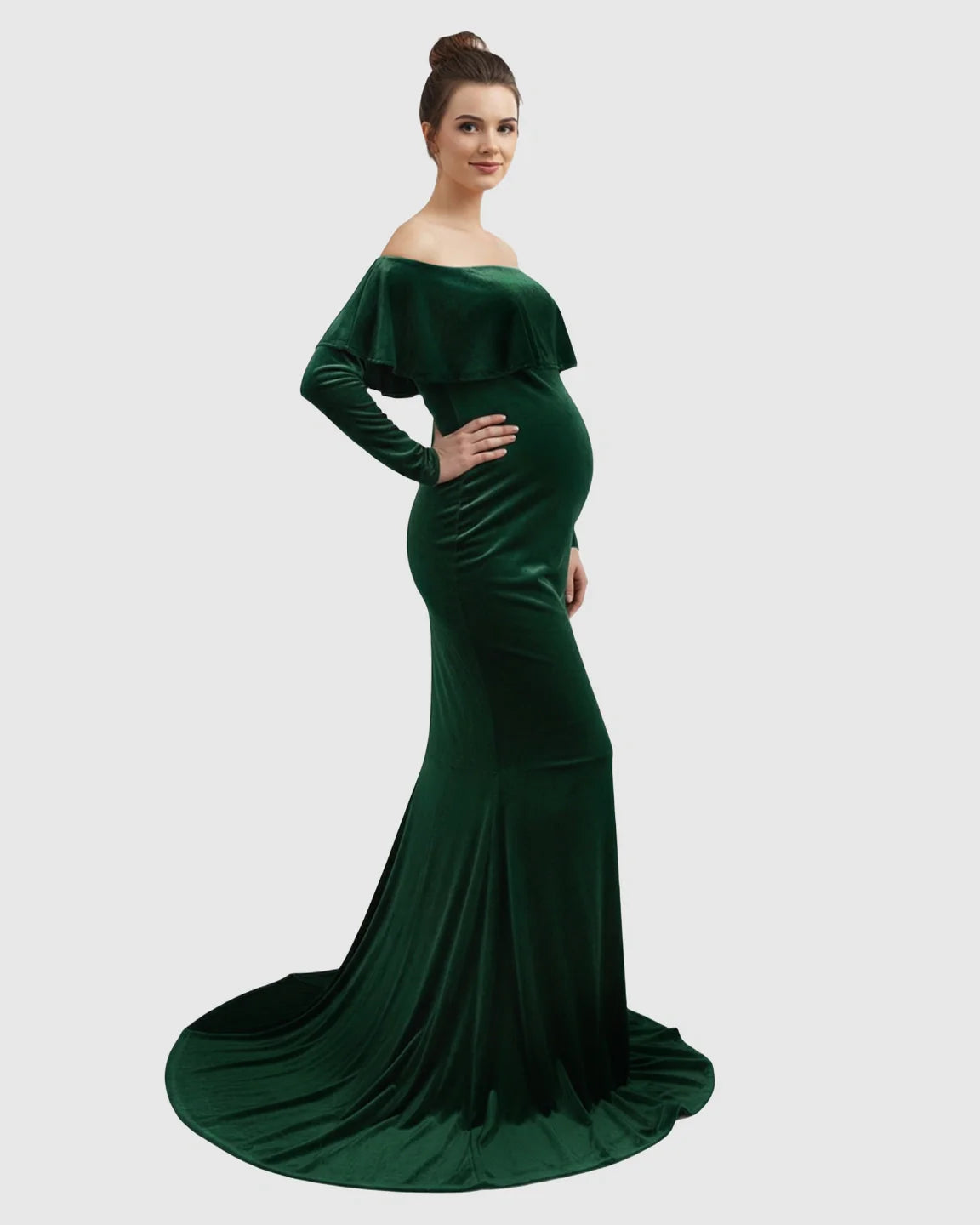 Emerald green velvet off-shoulder maternity gown with a fitted silhouette, long sleeves, and flowing train.