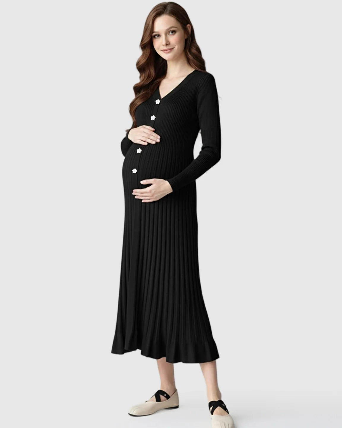 Pregnant woman in black ribbed knit maternity midi dress with V-neck, long sleeves, and white floral buttons.
