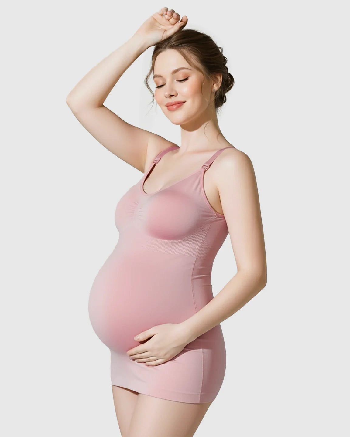 Pregnant woman in a pink, soft stretch, wireless maternity nursing bra and matching camisole.
