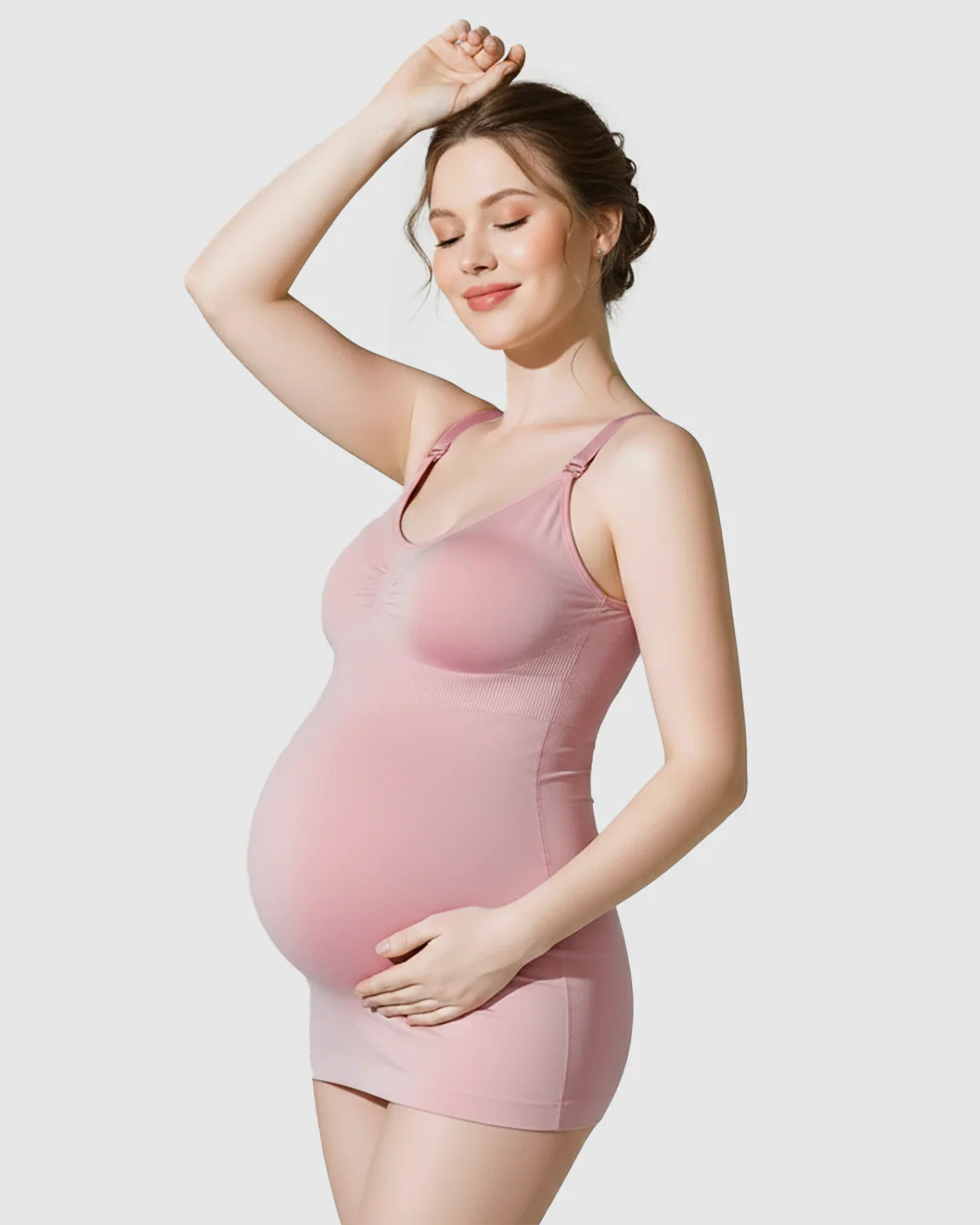 Pregnant woman in a pink soft stretch wireless maternity nursing bra and dress, smiling.