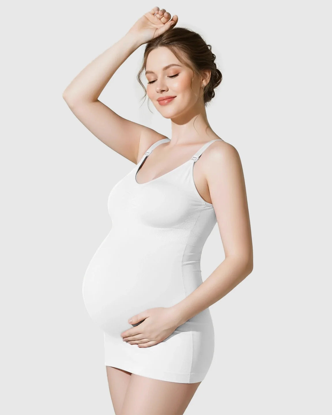 Pregnant woman wearing a white, soft stretch, wireless maternity nursing camisole dress.