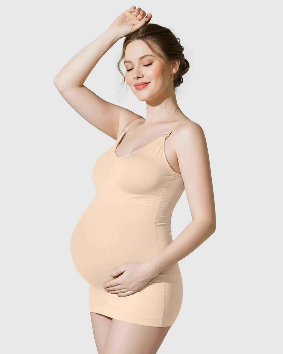 Pregnant woman wearing a soft stretch front-opening wireless maternity nursing bra and matching seamless tank in nude.
