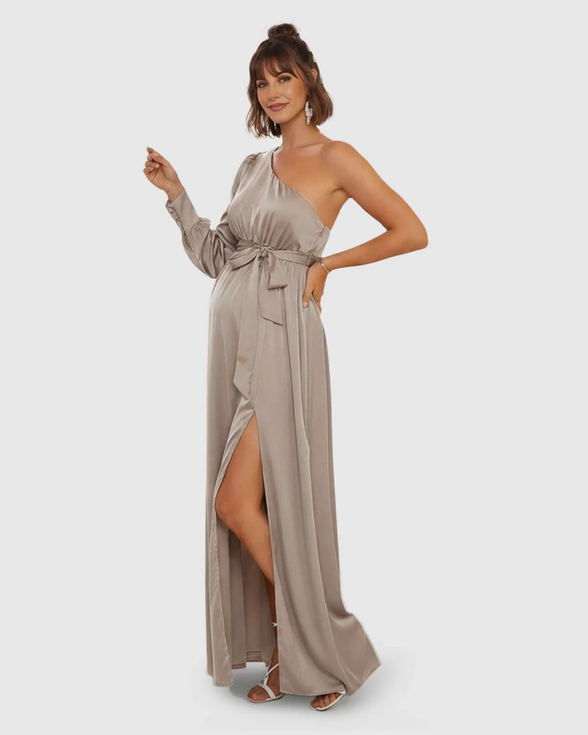 Elegant taupe satin one-shoulder maternity maxi dress with a high slit, long sleeve, and tie-waist.