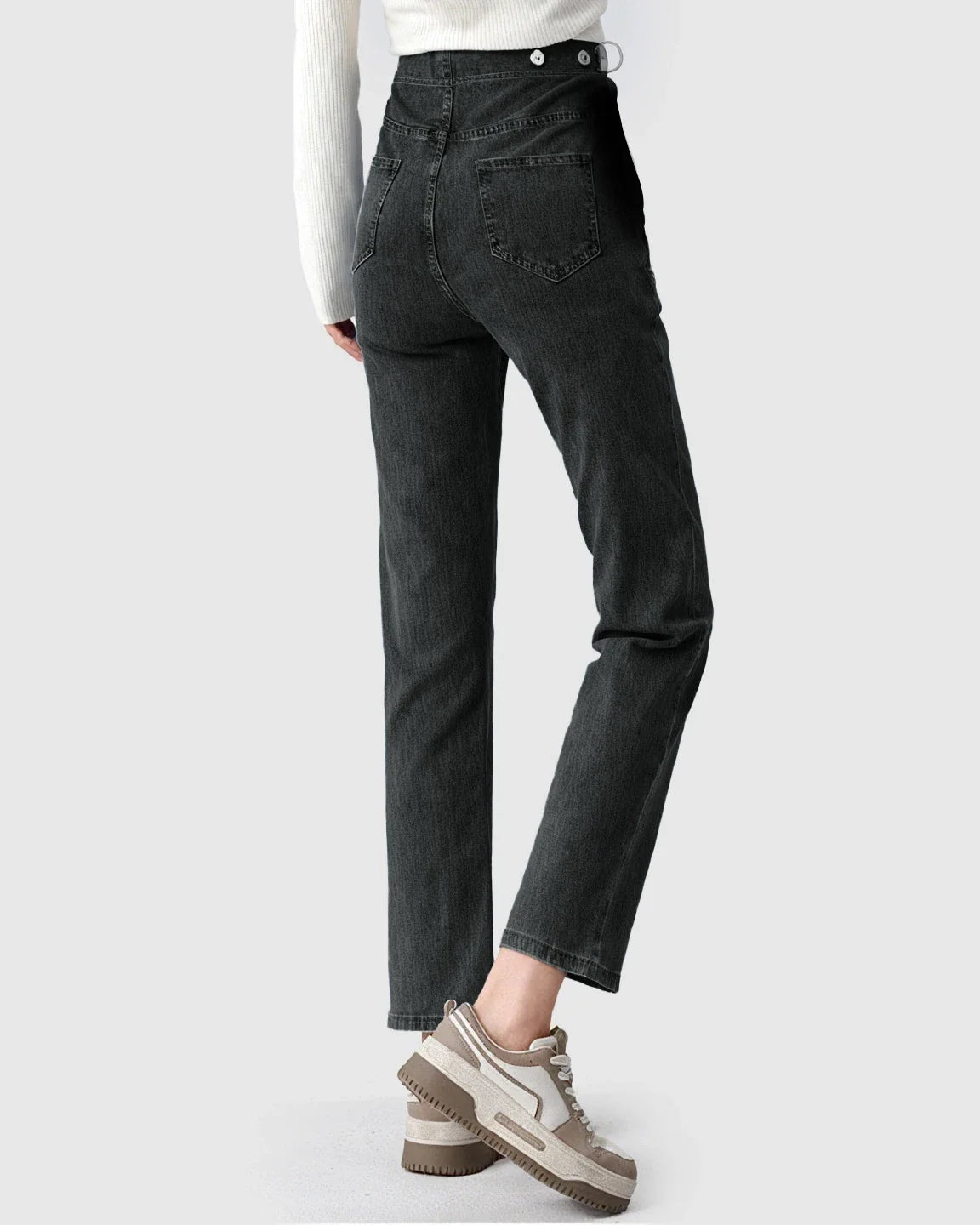 Model wearing dark wash straight-leg maternity denim jeans with a high-waist and button details.