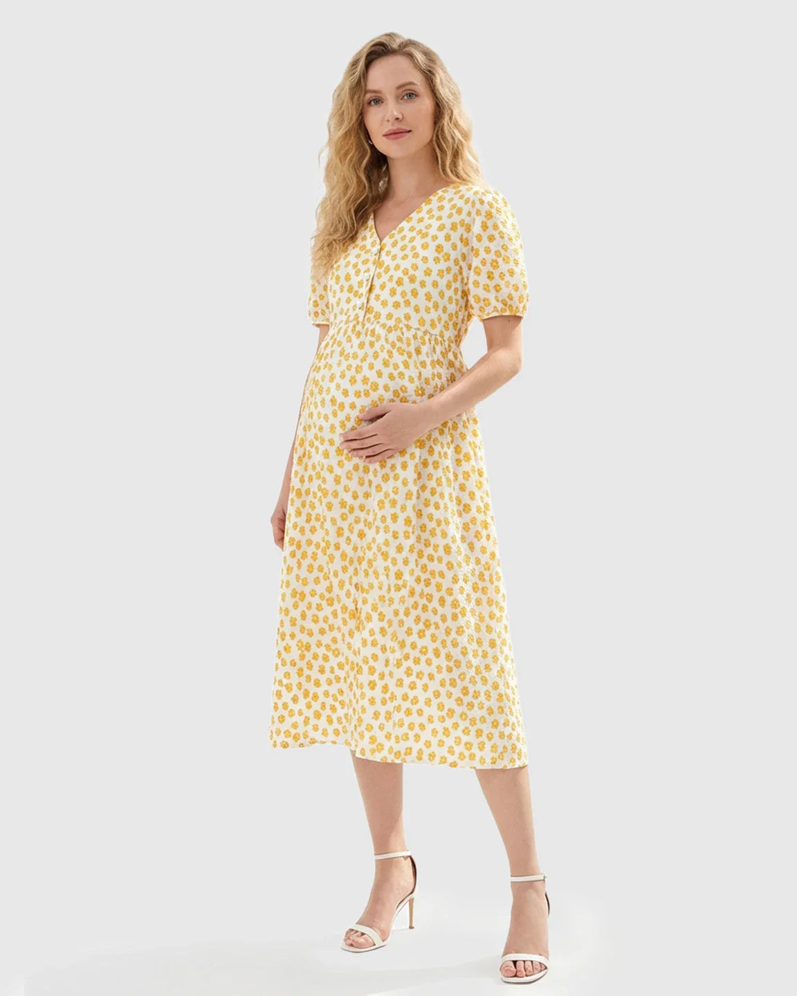 Pregnant woman in a white and yellow floral print button-front maternity nursing midi dress.