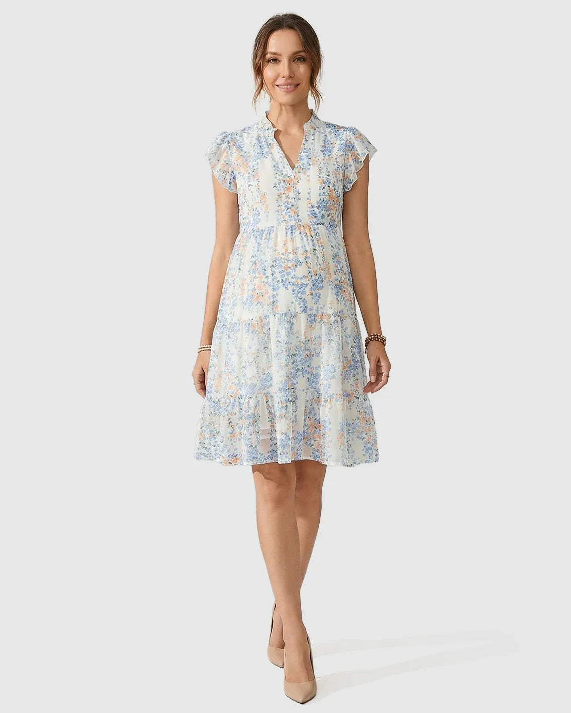 White chiffon A-line maternity dress with blue and orange floral print, flutter sleeves, and a V-neck.