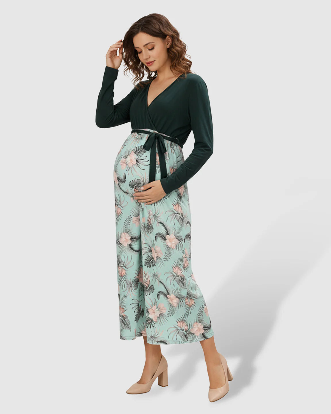 Maternity midi dress with deep green V-neck top, floral mint skirt, and tie waist.