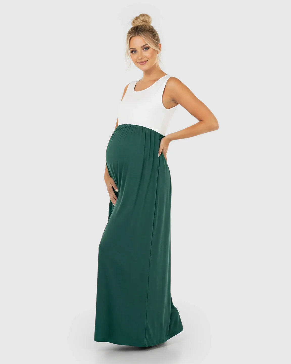 Maternity maxi dress with a white sleeveless top and a flowing dark green skirt, high-waisted for comfort.