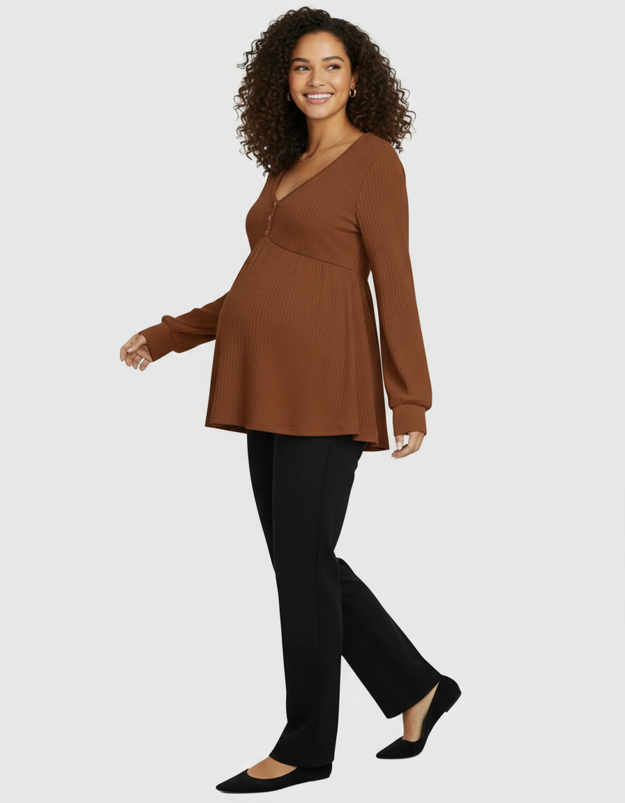 Smiling pregnant woman in a brown ribbed long-sleeve maternity top with buttons and black pants.