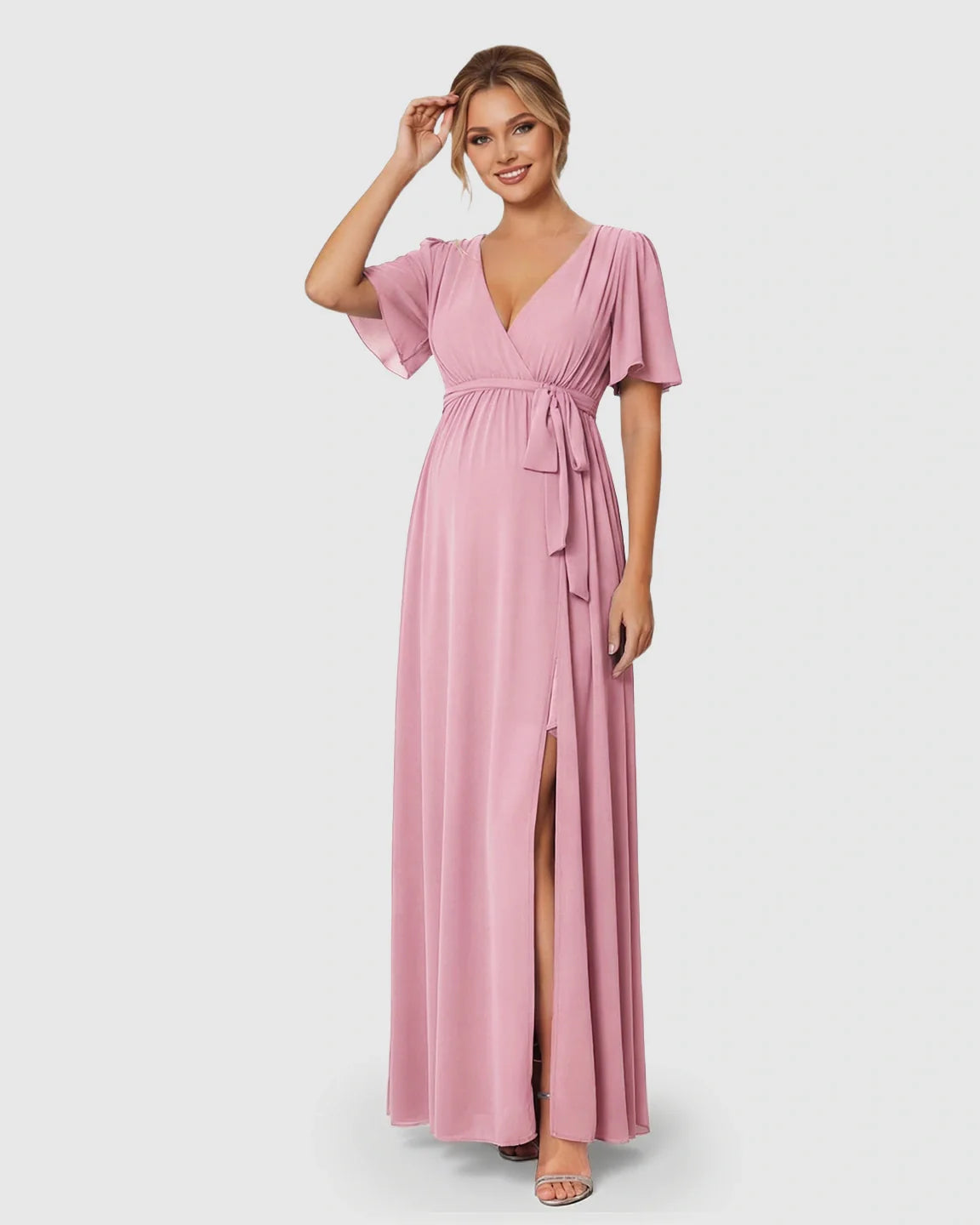 Pink surplice V-neck flutter sleeve maternity maxi dress with front slit and empire waist tie.