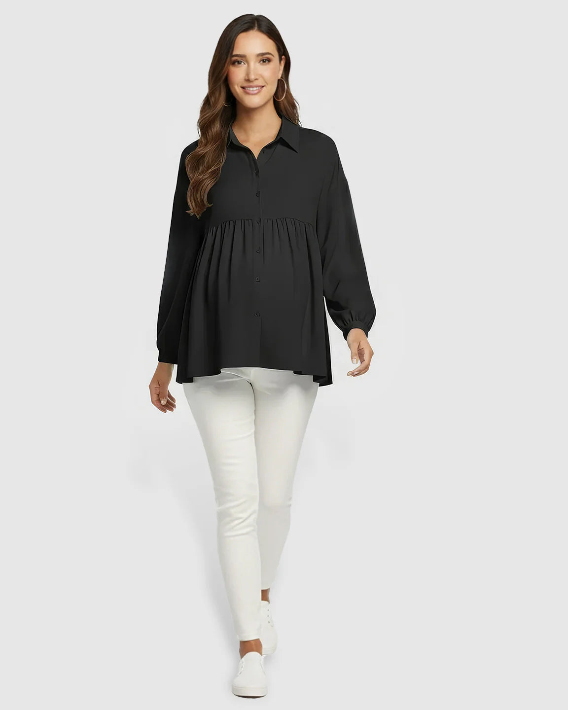 Woman in black chiffon Lapel Long Sleeve Maternity Shirt with babydoll fit, paired with white pants.