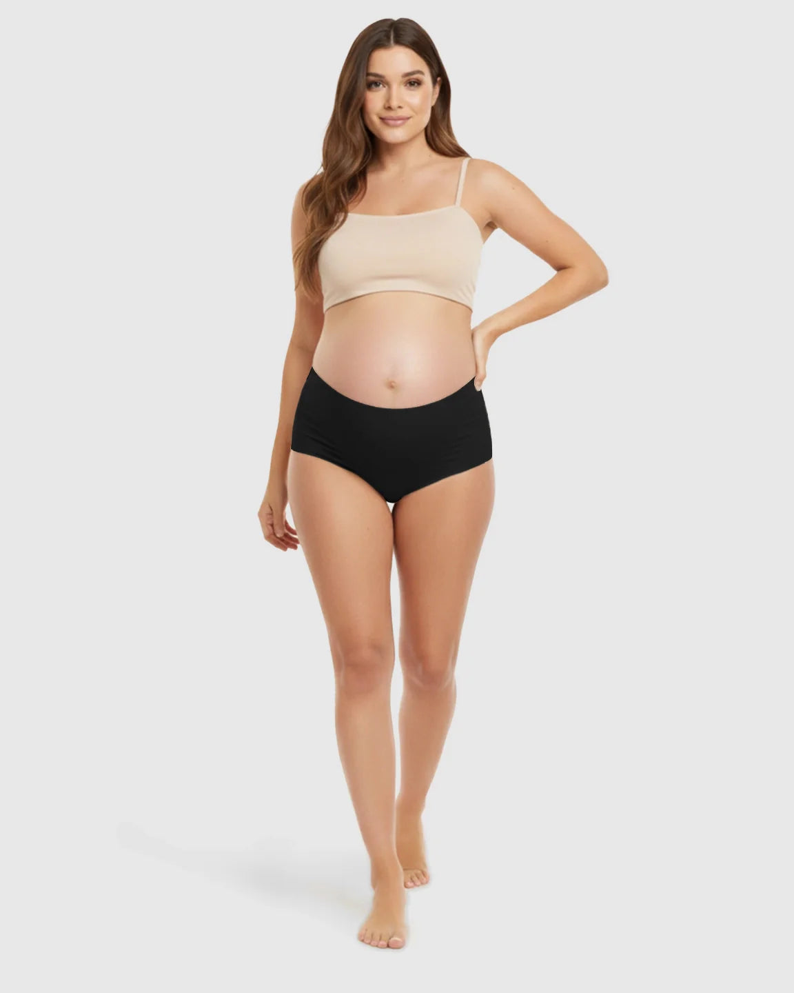 Smiling pregnant woman models black seamless high-waist maternity support underwear.