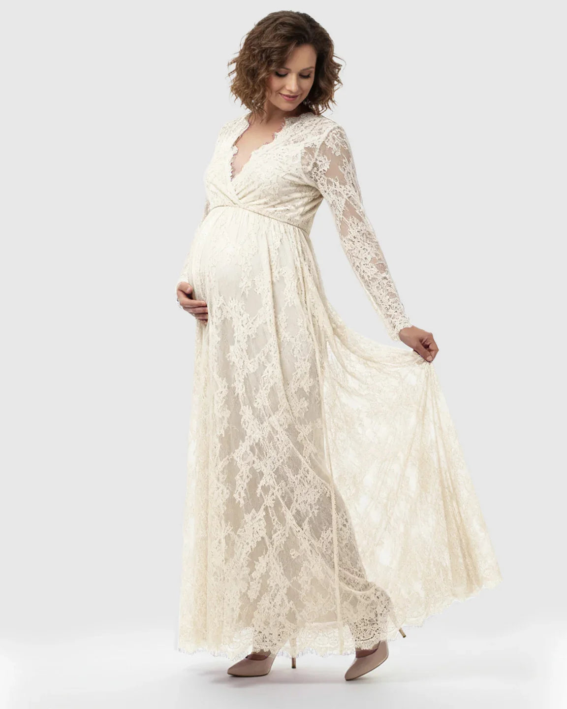 Sheer floral lace empire waist maternity maxi dress in cream, with long sleeves and a V-neck.