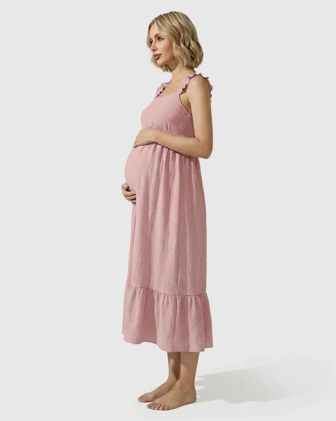 Pink ruffled strap maternity maxi dress with tiered skirt, empire waist, and textured fabric.