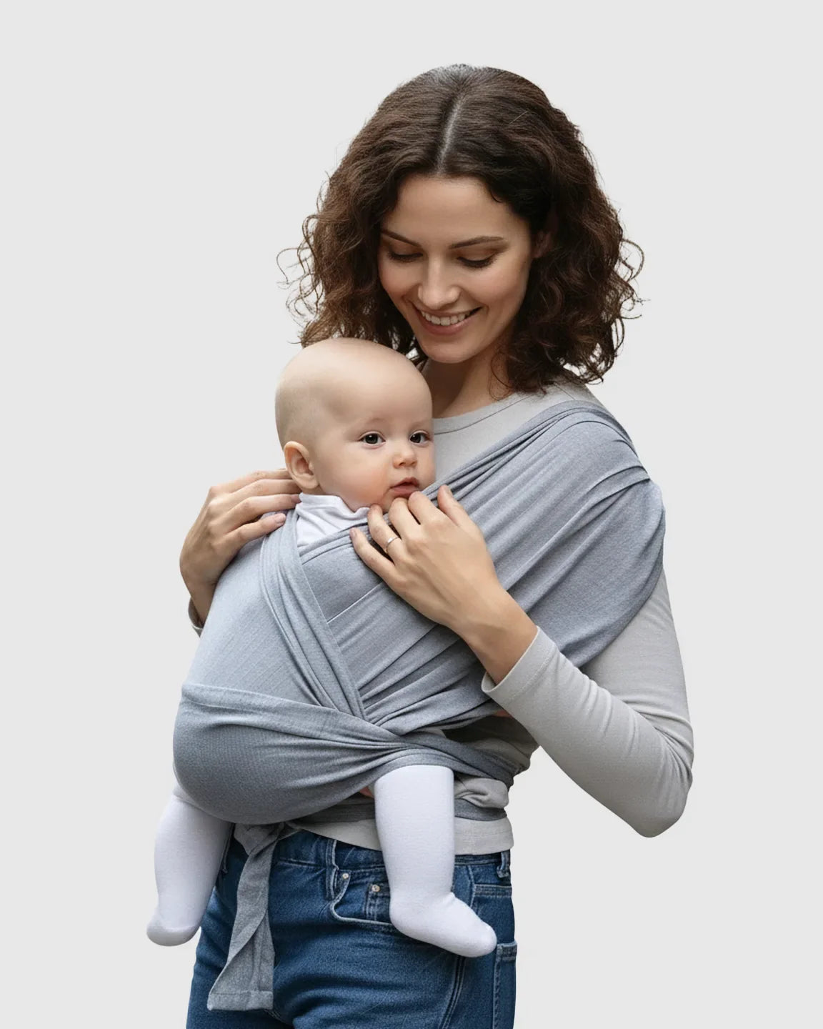 Woman smiling, wearing a light gray Bump Society Adjustable Wrap-Around Baby Carrier with a baby in a front-facing carry.