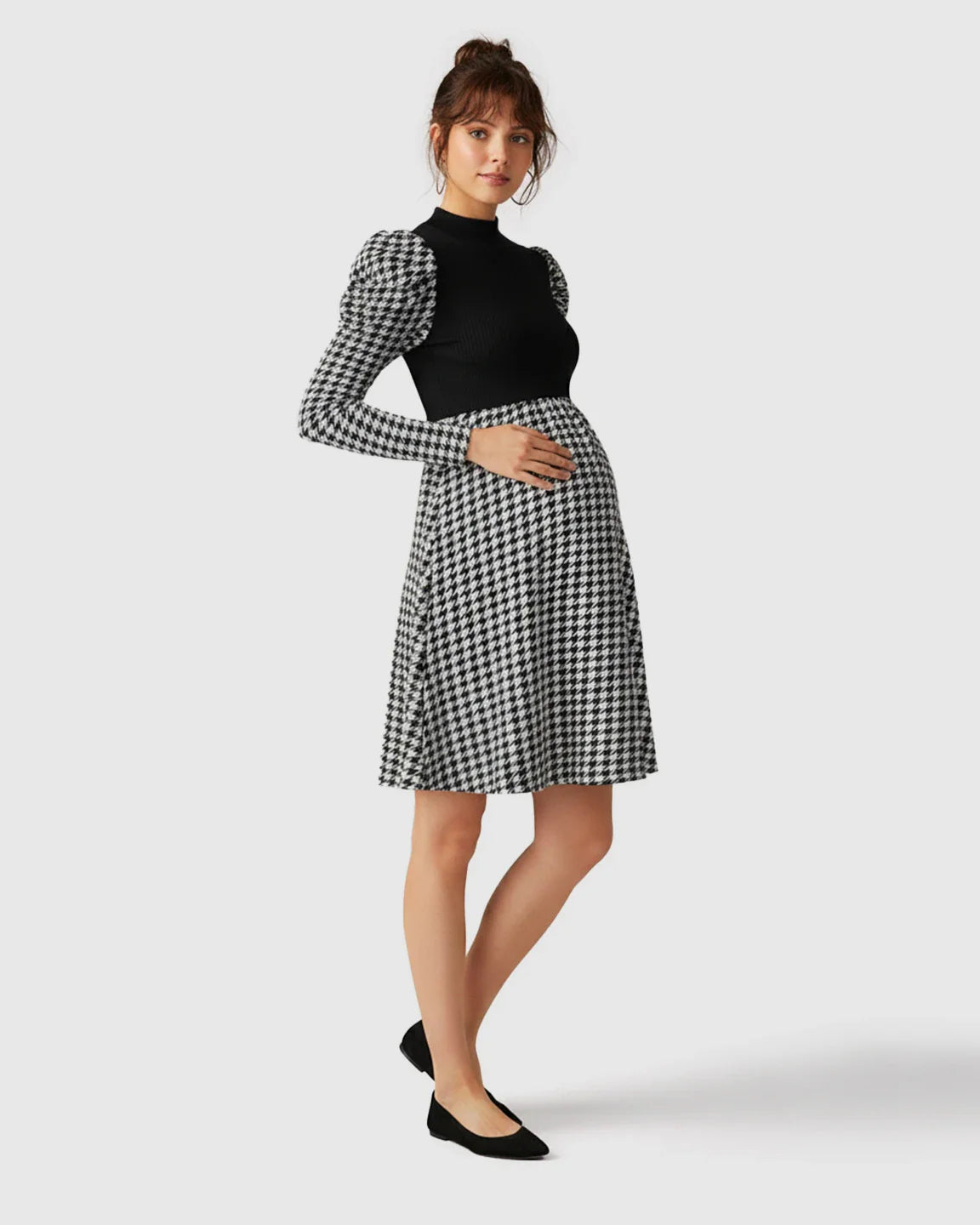 Elegant maternity short dress with black knit bodice, houndstooth skirt, and puff sleeves.