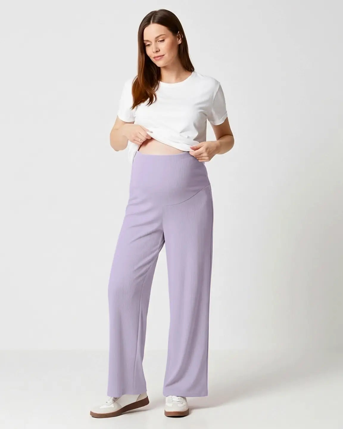 Woman in soft lavender wide-leg stretch maternity pants with over-bump waistband and white t-shirt.