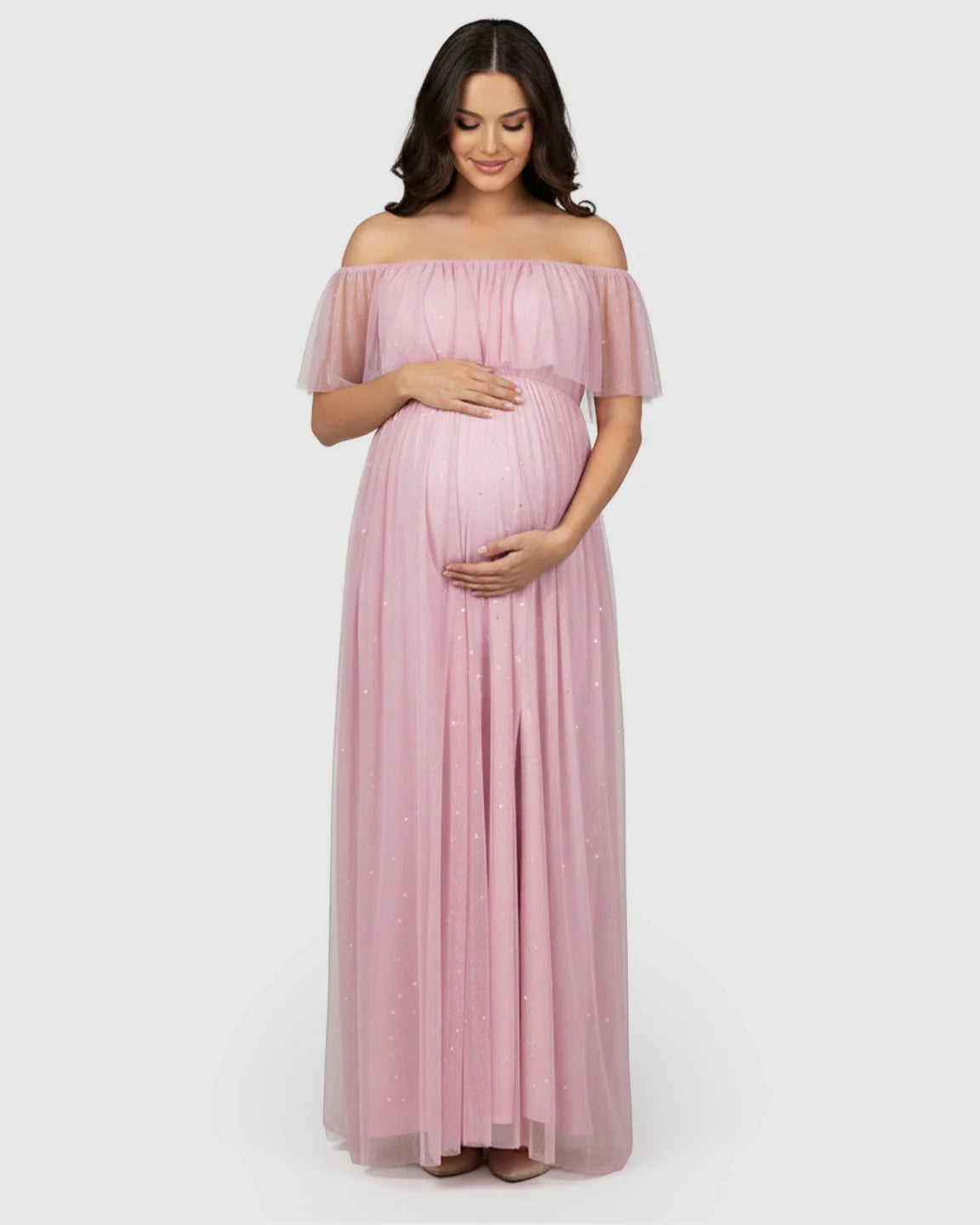 Pink off-shoulder mesh maternity gown with flutter neckline, high slit, and subtle sparkle.