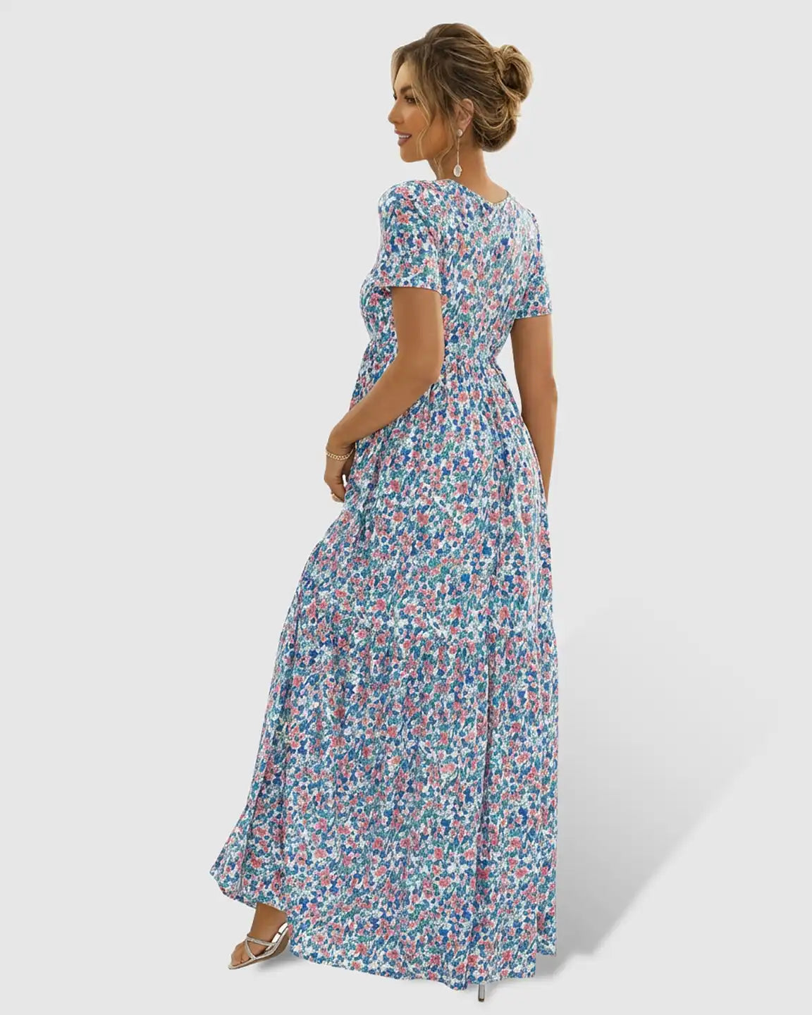 Maternity maxi dress with short sleeves, round neckline, and a flowing blue, pink, and green floral chiffon skirt.