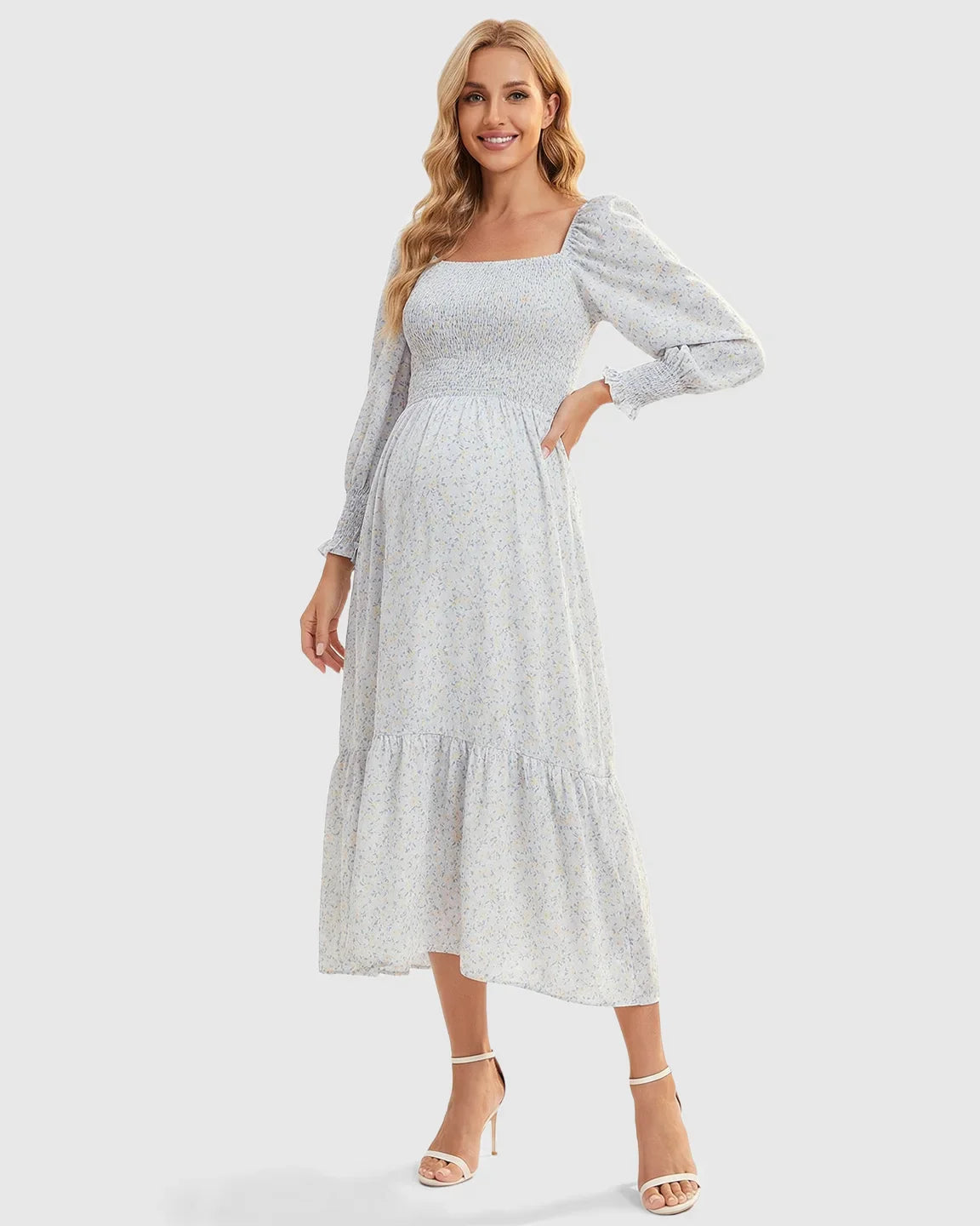 Smocked floral long sleeve maternity midi dress in light blue with yellow flowers, square neckline, and tiered skirt.