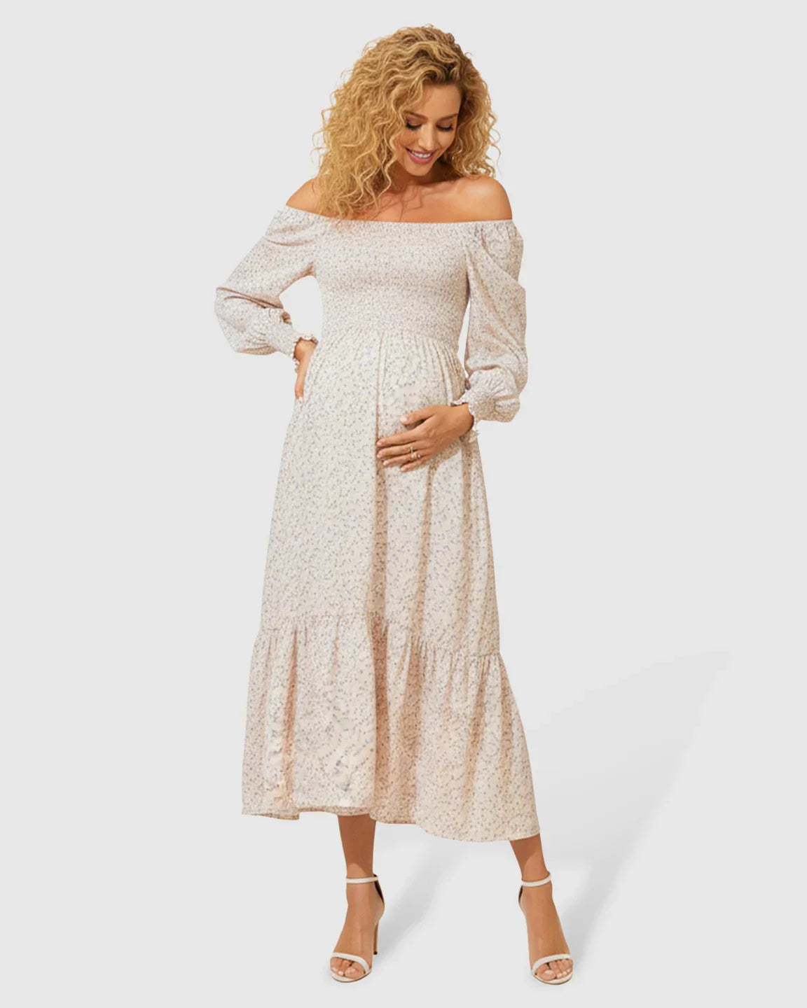 Blush off-shoulder floral maternity midi dress with smocked bodice and tiered skirt.