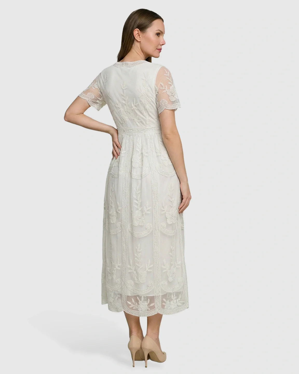 Woman in an ivory lace maternity midi dress with V-neck, three-quarter sleeves, and a soft swing skirt.