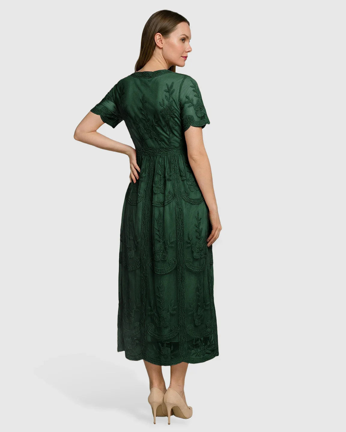 Woman in a dark green lace maternity midi dress with V-neck, short sleeves, and swing skirt.