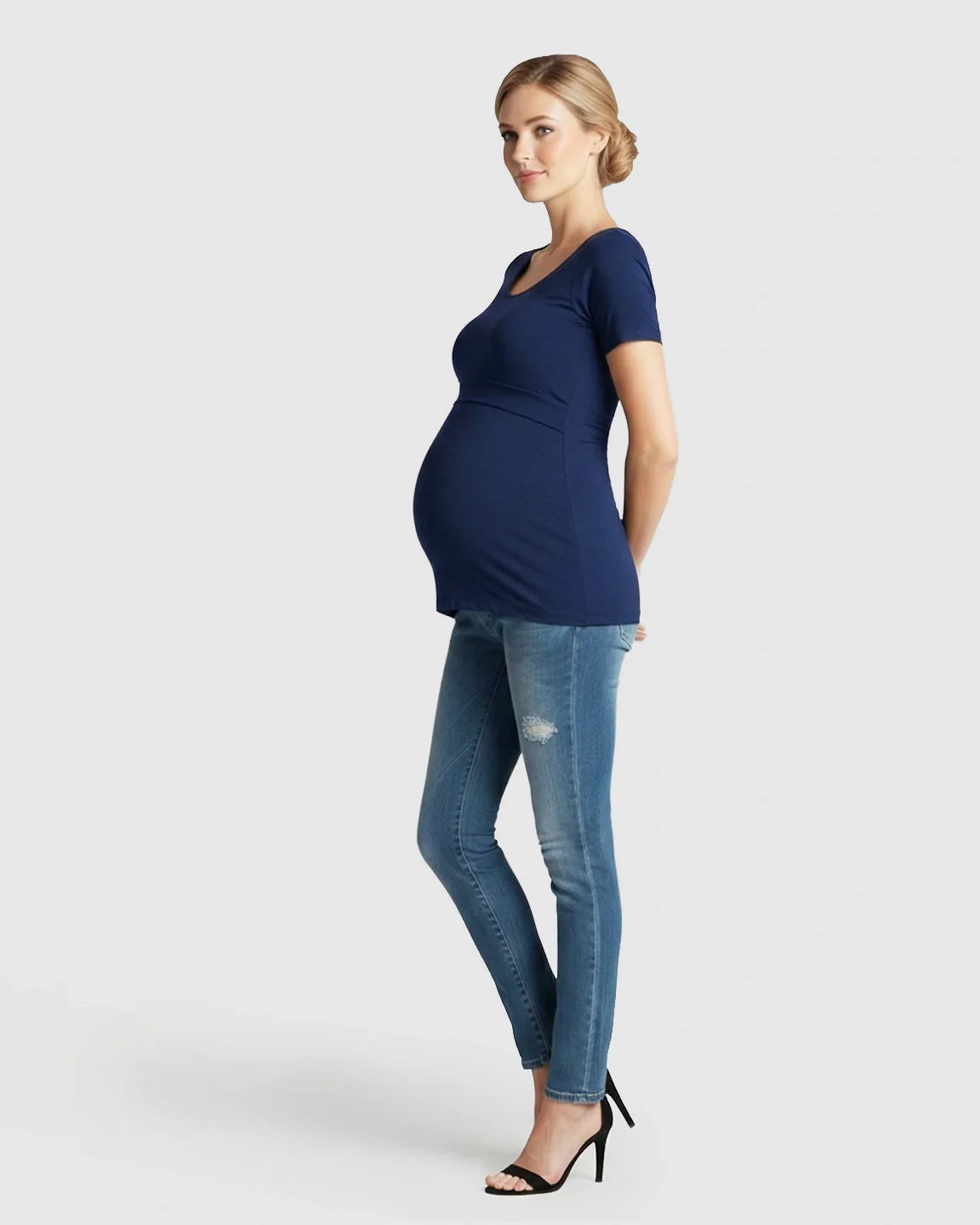 Pregnant woman in a navy stretch-fit V-neck nursing t-shirt and jeans.
