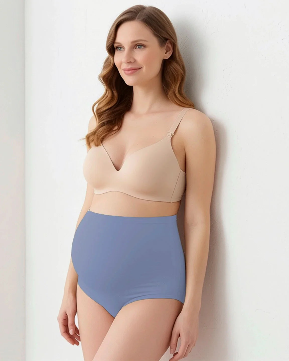 Smiling pregnant woman models high-waist, full-coverage seamless maternity briefs in dusty blue.