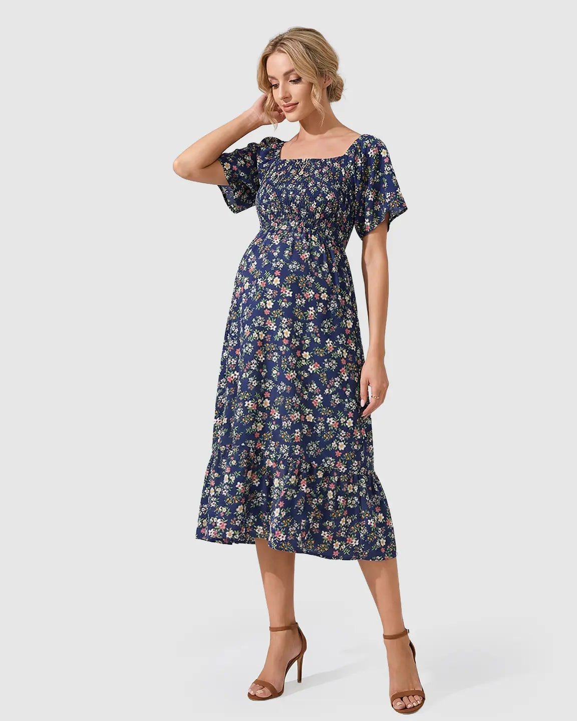 Navy floral flutter-sleeve smocked maternity midi dress with a tiered skirt.