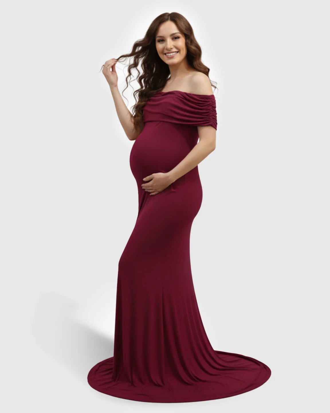 Smiling pregnant woman in a burgundy off-shoulder bodycon maternity mermaid gown.